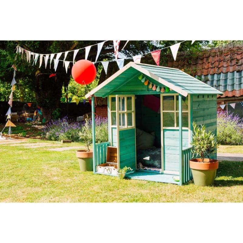 teal-wooden-playhouse-in-garden-with-open-doors-bunting-and-red-balloon