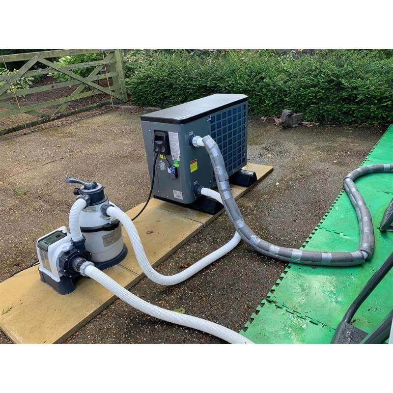thermotec-pool-heat-pump-and-filter-pump-connected-with-hoses-outdoors