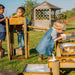 three-children-exploring-a-wooden-water-run-with-tipping-trays-and-flow-channels