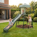 three-children-playing-on-garden-climbing-frame-with-tower-and-wavy-slide