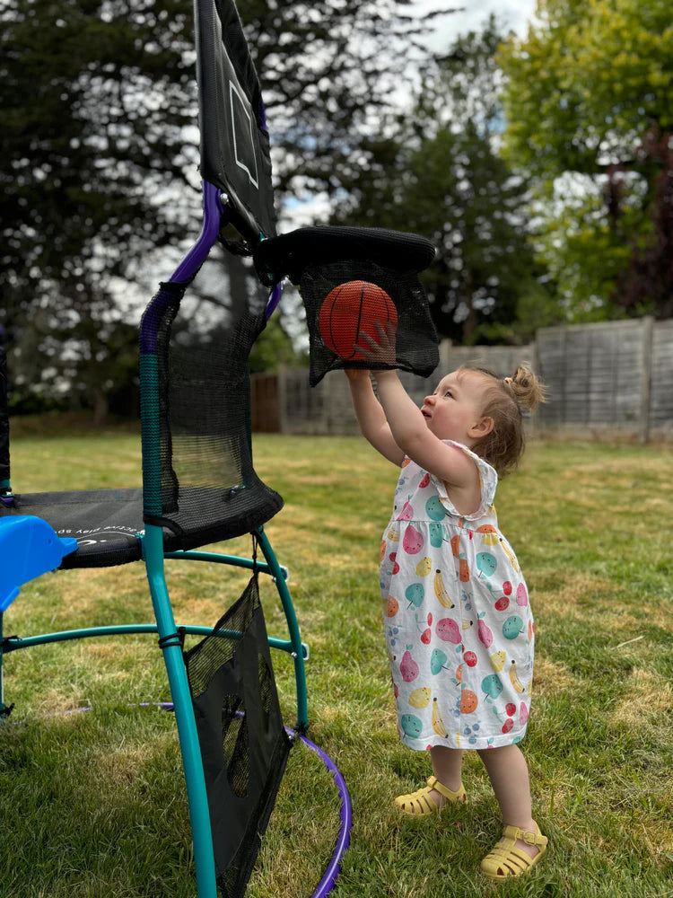 toddler-dropping-mini-basketball-into-play-centre-hoop