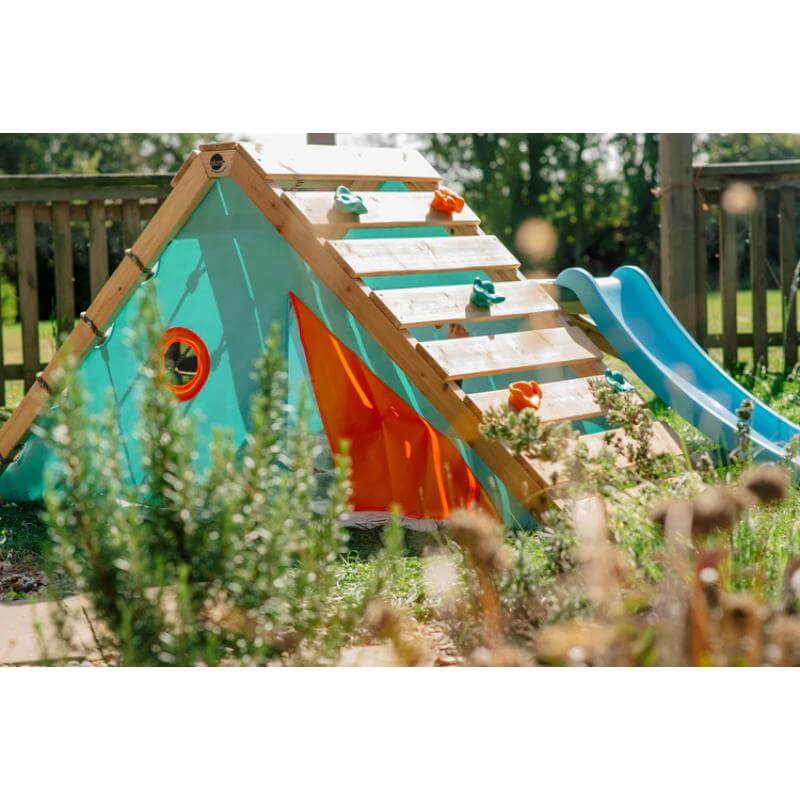 triangular-wooden-playcentre-with-blue-slide-orange-door-flap-and-round-side-window-in-garden