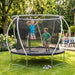 two-children-jumping-on-modern-backyard-trampoline-with-parent-nearby