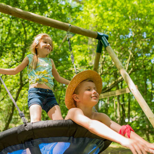 two-children-laughing-and-playing-together-on-a-plum-spider-monkey-wooden-swing-set-in-a-sunny-garden