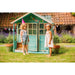 two-children-standing-outside-teal-wooden-playhouse-with-open-door