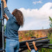 woman-assembling-plum-spacezone-trampoline-enclosure-with-child-holding-pole-covers