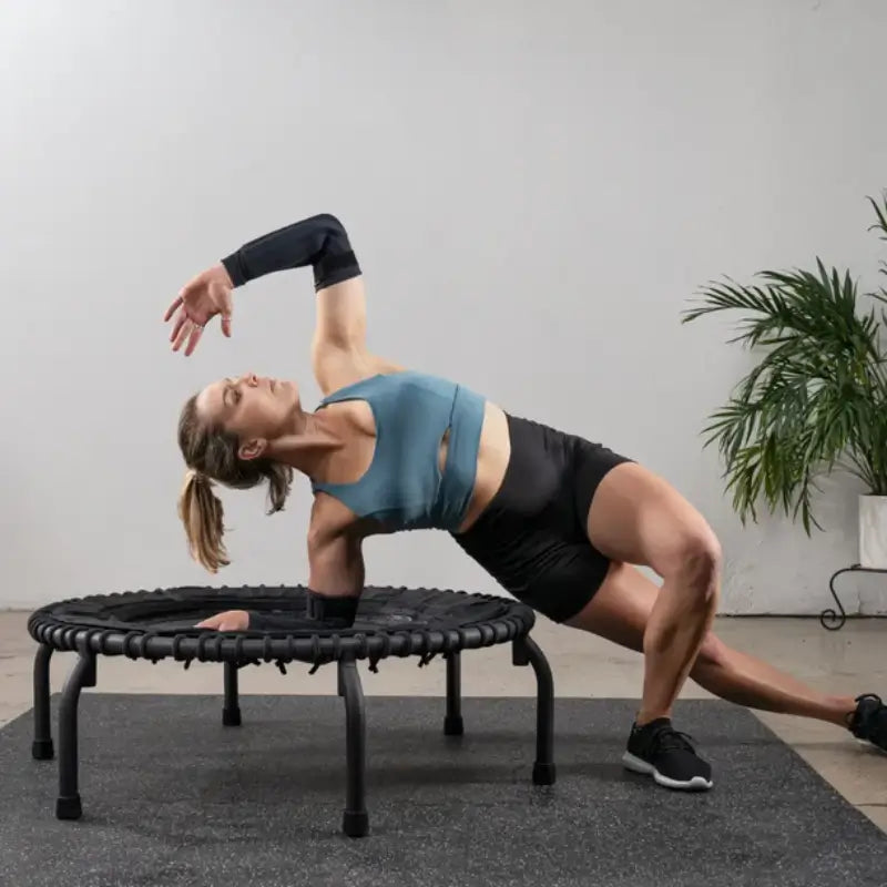 woman-stretching-on-jumpsport-350-fitness-trampoline