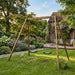 wooden-double-garden-swing-set-in-a-flower-filled-family-backyard