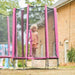 young-child-standing-inside-pink-enclosed-trampoline